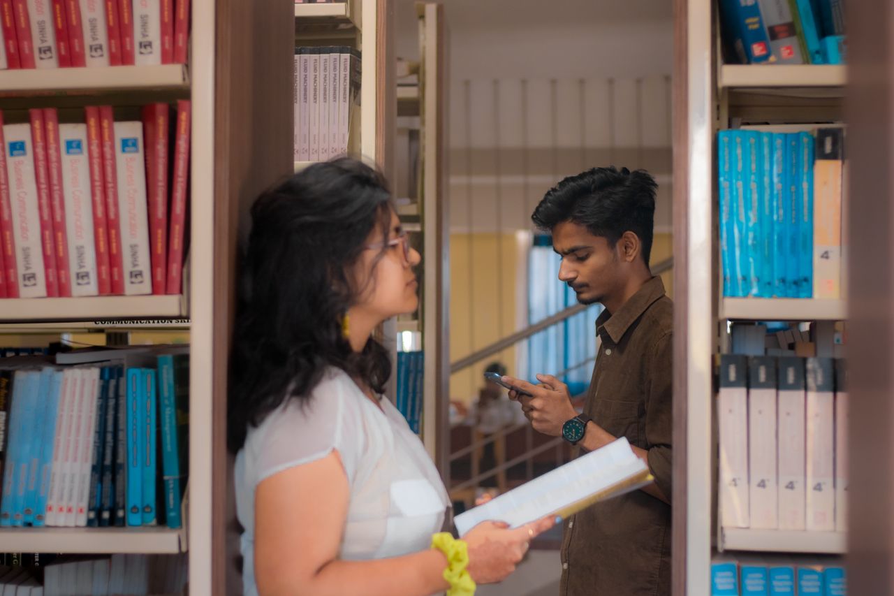 Services A young man and woman study surrounded by books in a New Delhi library.
