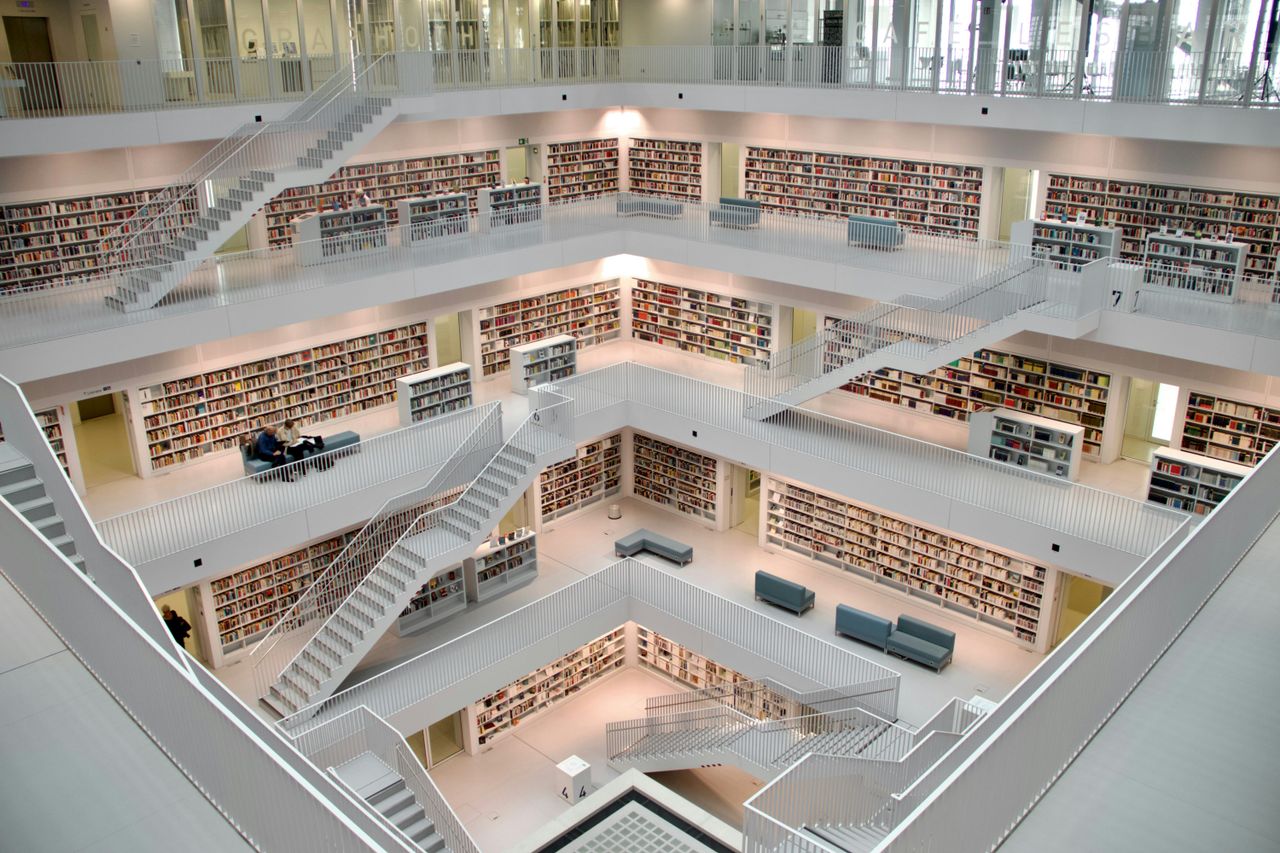 Home Spacious multi-story library interior in Stuttgart showcasing modern architecture and design.